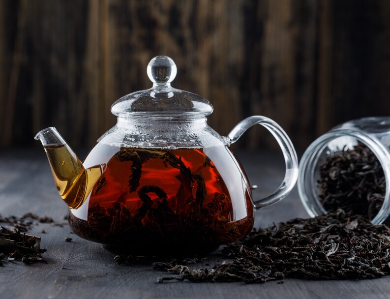 [fpdl.in]_black-tea-with-dry-tea-in-a-teapot-on-wooden-surface-side-view_176474-6302_medium.jpg